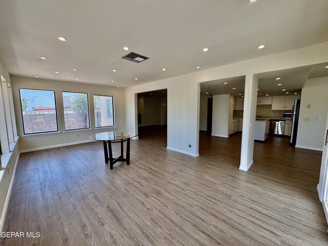 536 Satellite Dr, El Paso, TX 79912 - unfurnished living room with wood finished floors and recessed lighting