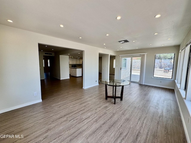 536 Satellite Dr, El Paso, TX 79912 - unfurnished living room featuring wood finished floors and recessed lighting