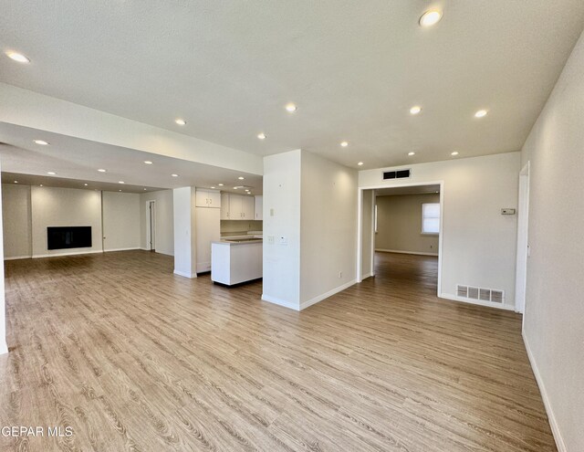 536 Satellite Dr, El Paso, TX 79912 - unfurnished living room featuring light wood-style floors and recessed lighting