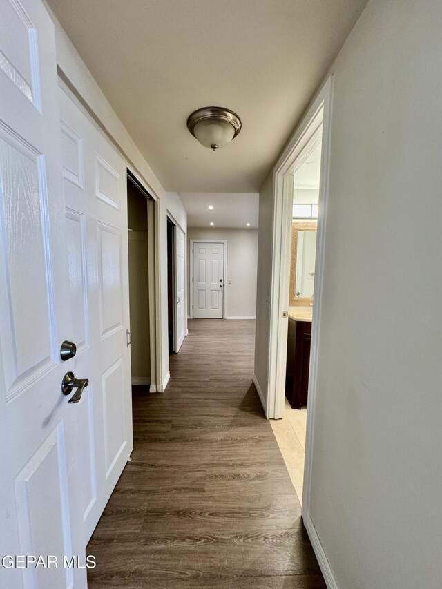 536 Satellite Dr, El Paso, TX 79912 - corridor featuring dark wood finished floors and recessed lighting