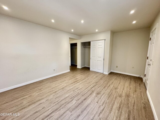 536 Satellite Dr, El Paso, TX 79912 - unfurnished bedroom featuring wood finished floors and recessed lighting