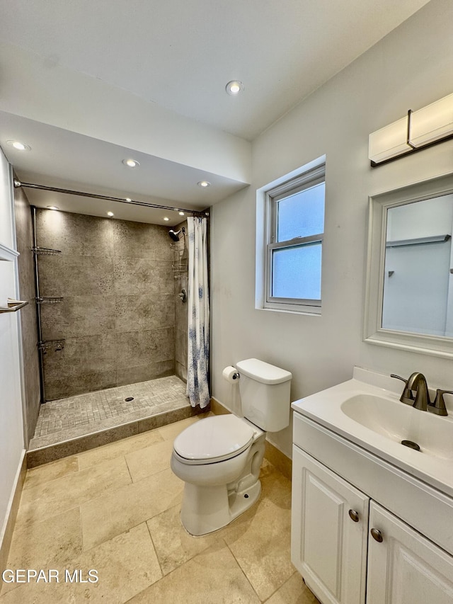 536 Satellite Dr, El Paso, TX 79912 - bathroom featuring vanity, a tile shower, recessed lighting, and tile patterned floors