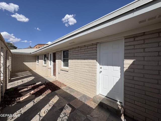 536 Satellite Dr, El Paso, TX 79912 - doorway to property with brick siding and a patio