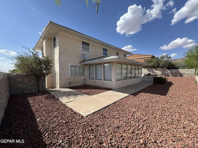 536 Satellite Dr, El Paso, TX 79912 - rear view of house with a sunroom and stucco siding