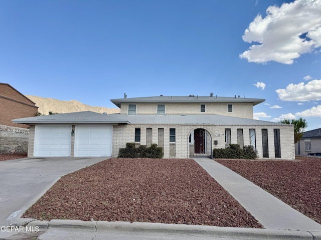 536 Satellite Dr, El Paso, TX 79912 - view of front of property with an attached garage, concrete driveway, and brick siding