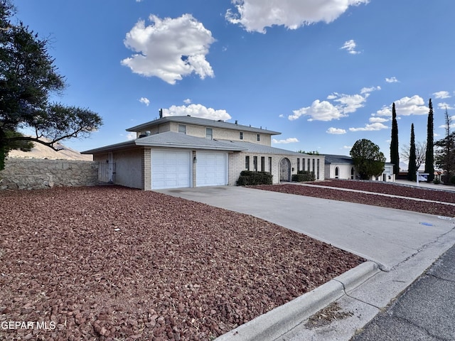 536 Satellite Dr, El Paso, TX 79912 - traditional home featuring driveway, an attached garage, and brick siding