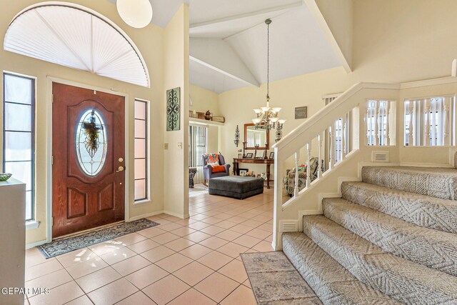 9769 Galilee Dr, El Paso, TX 79927 - entryway featuring high vaulted ceiling, stairway, a chandelier, and light tile patterned floors