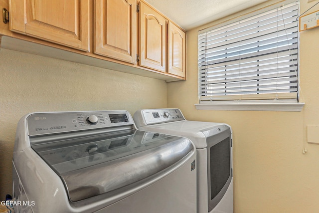 9769 Galilee Dr, El Paso, TX 79927 - laundry area featuring washer and dryer and cabinet space