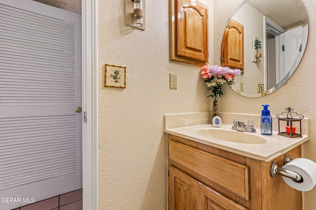 9769 Galilee Dr, El Paso, TX 79927 - bathroom with vanity and a textured wall
