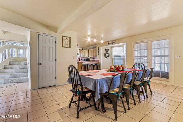 9769 Galilee Dr, El Paso, TX 79927 - dining area featuring light tile patterned floors, plenty of natural light, track lighting, stairs, and a textured ceiling