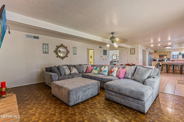 9769 Galilee Dr, El Paso, TX 79927 - living room with a textured ceiling and ceiling fan