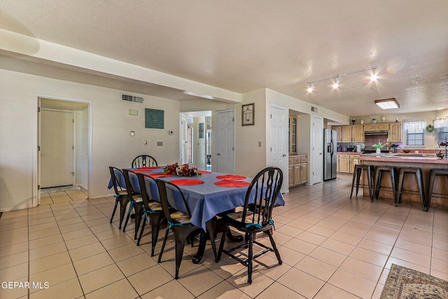 9769 Galilee Dr, El Paso, TX 79927 - dining room with light tile patterned floors and track lighting