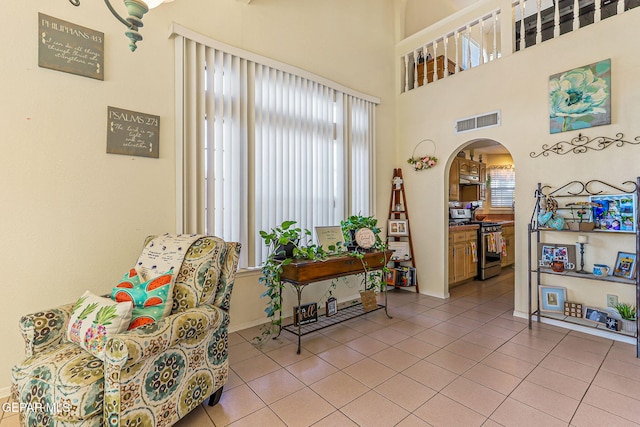 9769 Galilee Dr, El Paso, TX 79927 - sitting room with arched walkways and light tile patterned flooring