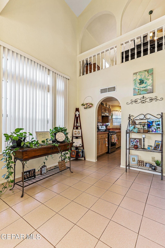 9769 Galilee Dr, El Paso, TX 79927 - entrance foyer featuring healthy amount of natural light, arched walkways, a towering ceiling, and light tile patterned floors