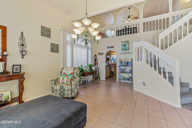 9769 Galilee Dr, El Paso, TX 79927 - sitting room featuring light tile patterned floors, stairway, ceiling fan, arched walkways, and high vaulted ceiling