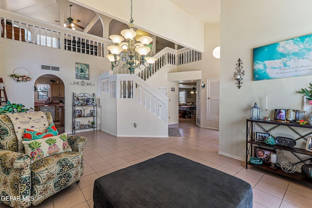 9769 Galilee Dr, El Paso, TX 79927 - living area with a high ceiling, ceiling fan, tile patterned flooring, stairway, and arched walkways