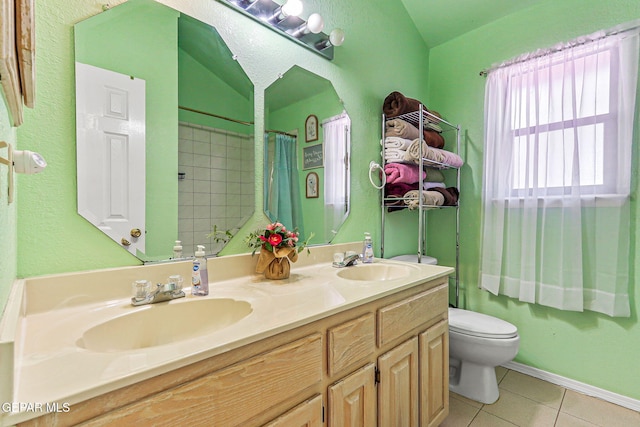 9769 Galilee Dr, El Paso, TX 79927 - bathroom featuring tile patterned flooring, double vanity, lofted ceiling, and a shower with curtain