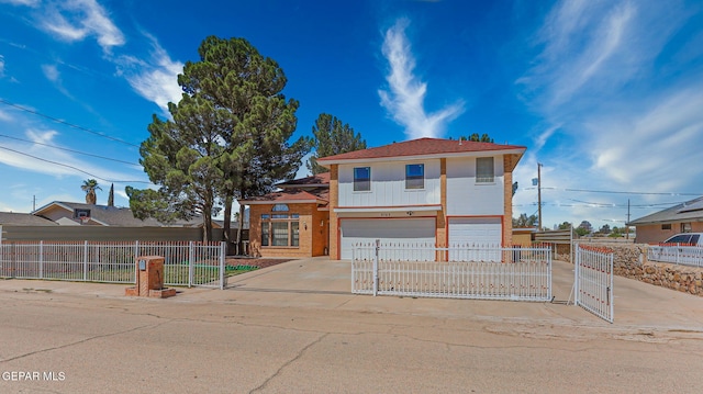 9769 Galilee Dr, El Paso, TX 79927 - view of front facade with a gate, an attached garage, driveway, a fenced front yard, and brick siding