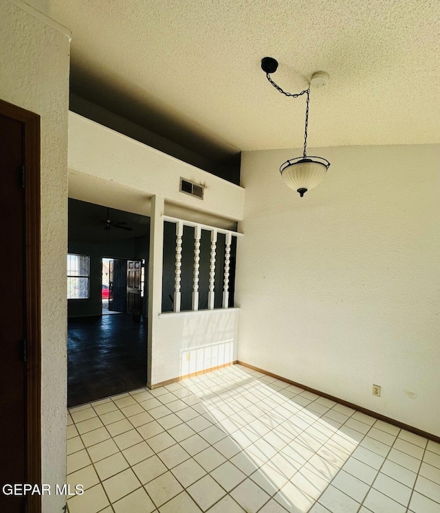 11049 Middledale St, El Paso, TX 79934 - unfurnished room featuring a textured ceiling, vaulted ceiling, light tile patterned flooring, ceiling fan, and a textured wall