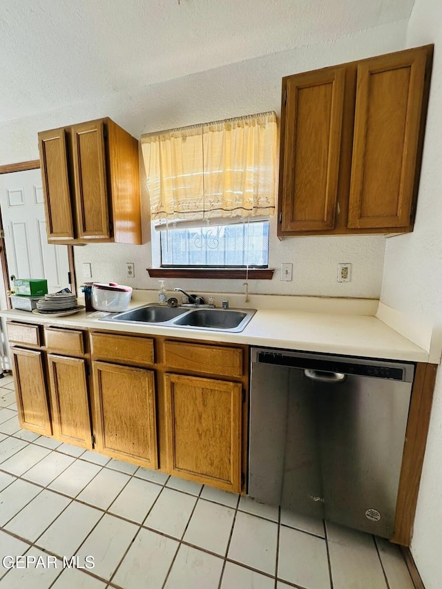 11049 Middledale St, El Paso, TX 79934 - kitchen with dishwasher, brown cabinets, light countertops, a textured ceiling, and light tile patterned flooring