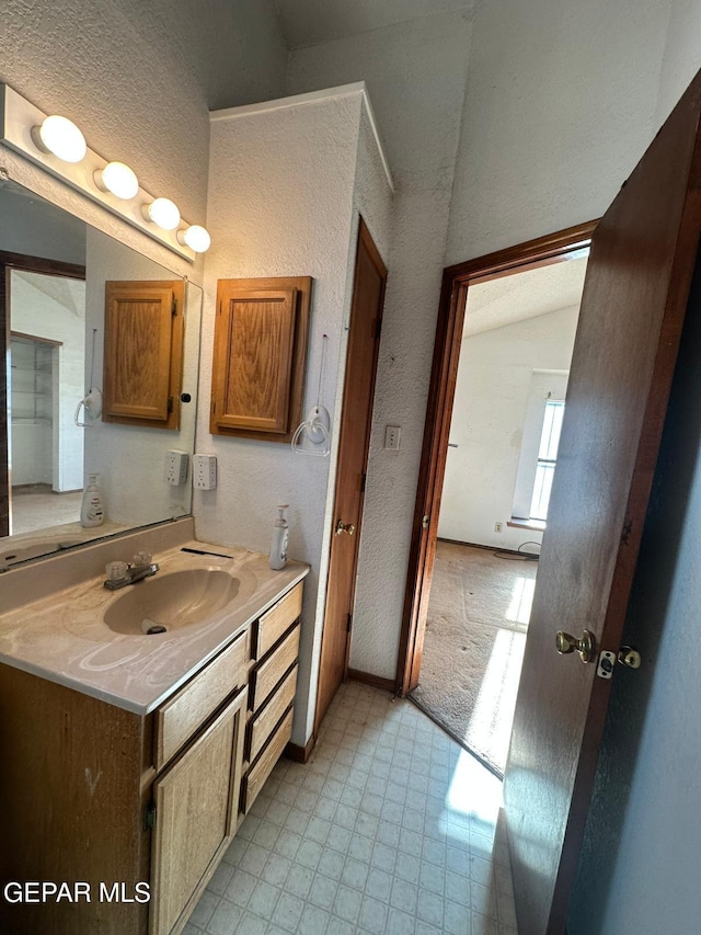 11049 Middledale St, El Paso, TX 79934 - bathroom with vanity, a textured wall, and tile patterned floors