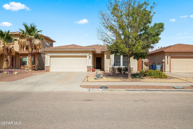 11202 Redstone Peak Place, El Paso, TX 79934 - view of front of property featuring stucco siding, an attached garage, concrete driveway, and stone siding