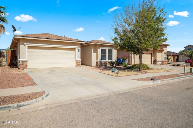 11202 Redstone Peak Place, El Paso, TX 79934 - view of front of house with stucco siding, a garage, driveway, and stone siding