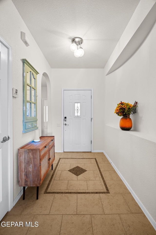 11202 Redstone Peak Place, El Paso, TX 79934 - entryway featuring arched walkways, a textured ceiling, and tile patterned flooring
