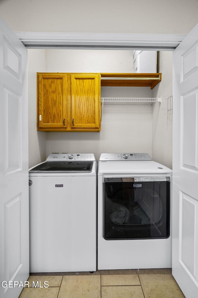 11202 Redstone Peak Place, El Paso, TX 79934 - washroom featuring cabinet space, washer and dryer, and light tile patterned flooring