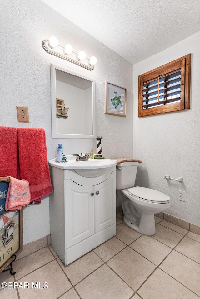 612 Firedale Ln, El Paso, TX 79912 - bathroom featuring vanity, a textured ceiling, a textured wall, and tile patterned floors