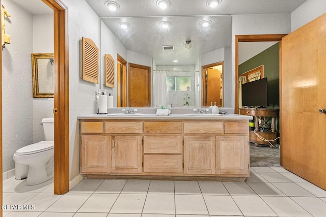 612 Firedale Ln, El Paso, TX 79912 - full bathroom with double vanity, a shower, and tile patterned floors