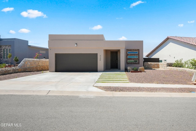 7722 Enchanted Ridge Dr, El Paso, TX 79911 - view of front facade with a garage, stucco siding, and concrete driveway