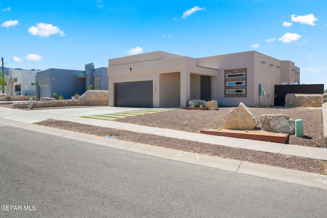 7722 Enchanted Ridge Dr, El Paso, TX 79911 - view of front of home with stucco siding, a garage, and concrete driveway
