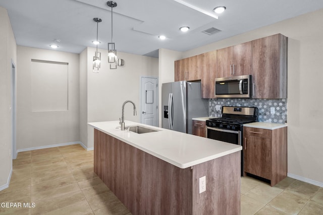 7722 Enchanted Ridge Dr, El Paso, TX 79911 - kitchen with stainless steel appliances, light tile patterned floors, decorative backsplash, light countertops, and pendant lighting