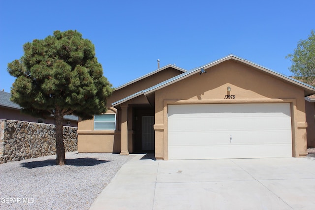 13978 Vaquero Rock Dr, El Paso, TX 79938 - view of front of home featuring stucco siding, concrete driveway, and an attached garage