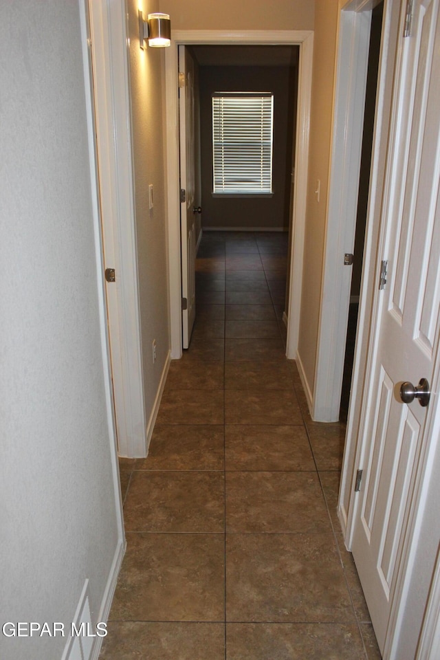 13978 Vaquero Rock Dr, El Paso, TX 79938 - corridor featuring baseboards and dark tile patterned flooring