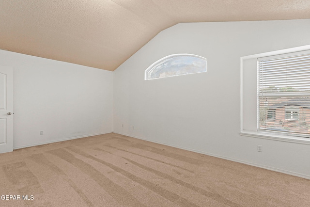 6736 Dakota Ridge Dr, El Paso, TX 79912 - additional living space featuring vaulted ceiling, plenty of natural light, carpet, and a textured ceiling