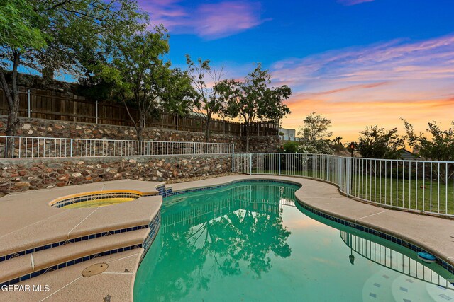 6736 Dakota Ridge Dr, El Paso, TX 79912 - pool at dusk featuring a fenced backyard and a pool with connected hot tub