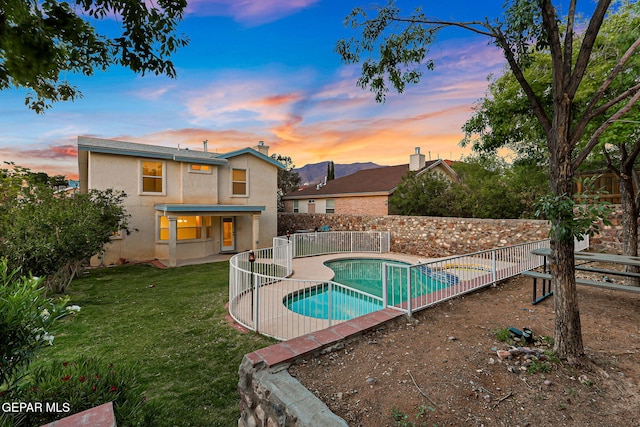 6736 Dakota Ridge Dr, El Paso, TX 79912 - pool at dusk with a fenced backyard and a patio