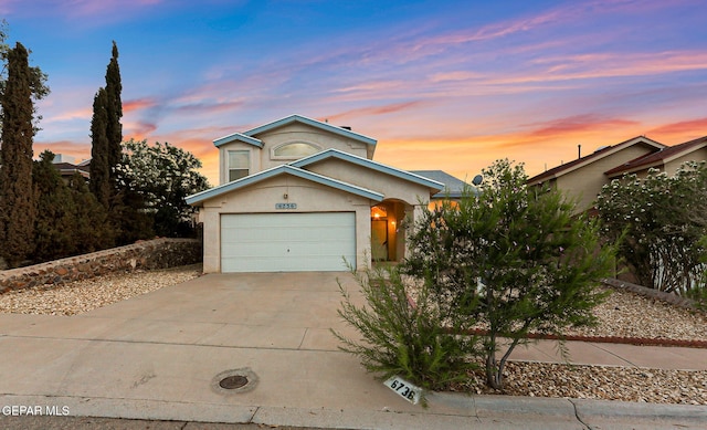 6736 Dakota Ridge Dr, El Paso, TX 79912 - view of front facade with concrete driveway, stucco siding, and a garage