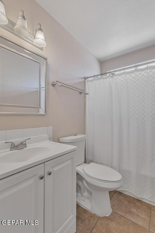 3280 Fawn Passage Place, El Paso, TX 79936 - bathroom featuring vanity, tile patterned floors, and a shower with curtain