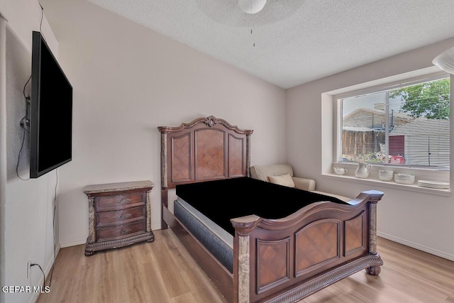 3280 Fawn Passage Place, El Paso, TX 79936 - bedroom featuring light wood-style flooring and a textured ceiling