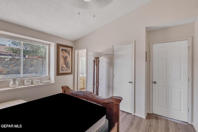 3280 Fawn Passage Place, El Paso, TX 79936 - bedroom featuring light wood-type flooring, a textured ceiling, and ensuite bath