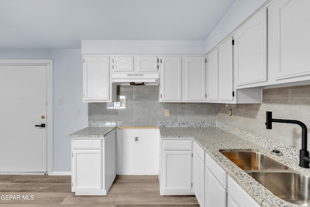 231 Romeria Dr, El Paso, TX 79907 - kitchen featuring ventilation hood, light stone counters, white cabinets, and light wood finished floors