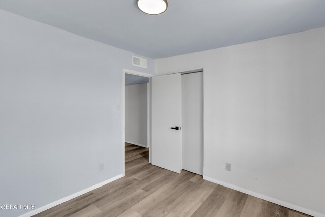 231 Romeria Dr, El Paso, TX 79907 - unfurnished bedroom featuring wood finished floors and a closet