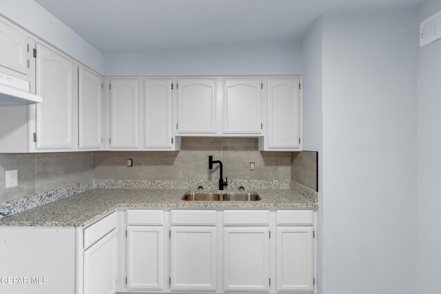 231 Romeria Dr, El Paso, TX 79907 - kitchen featuring white cabinetry and tasteful backsplash
