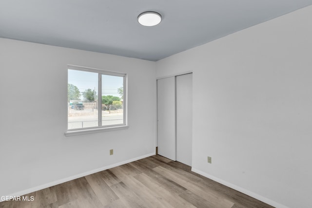 231 Romeria Dr, El Paso, TX 79907 - unfurnished bedroom with wood finished floors and a closet