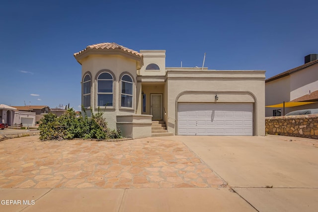 3148 Tierra Encino Dr, El Paso, TX 79938 - view of front of home with stucco siding, a garage, and concrete driveway