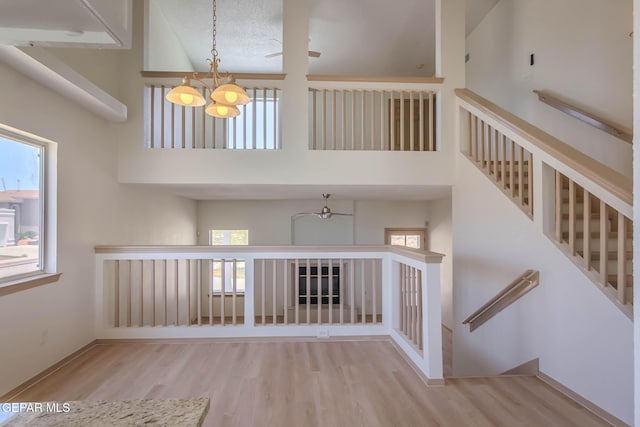 3148 Tierra Encino Dr, El Paso, TX 79938 - staircase featuring a chandelier, wood finished floors, and a high ceiling