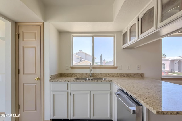 3148 Tierra Encino Dr, El Paso, TX 79938 - kitchen with dishwasher, glass insert cabinets, plenty of natural light, and white cabinets